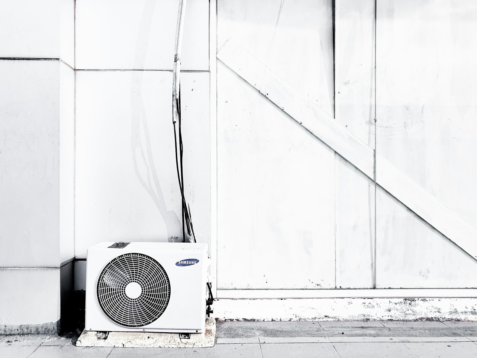 Outdoor air-conditioning unit beside a Utah-style home