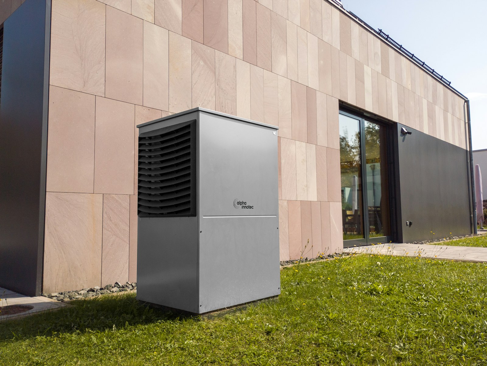 Modern outdoor heat pump beside an energy-efficient home