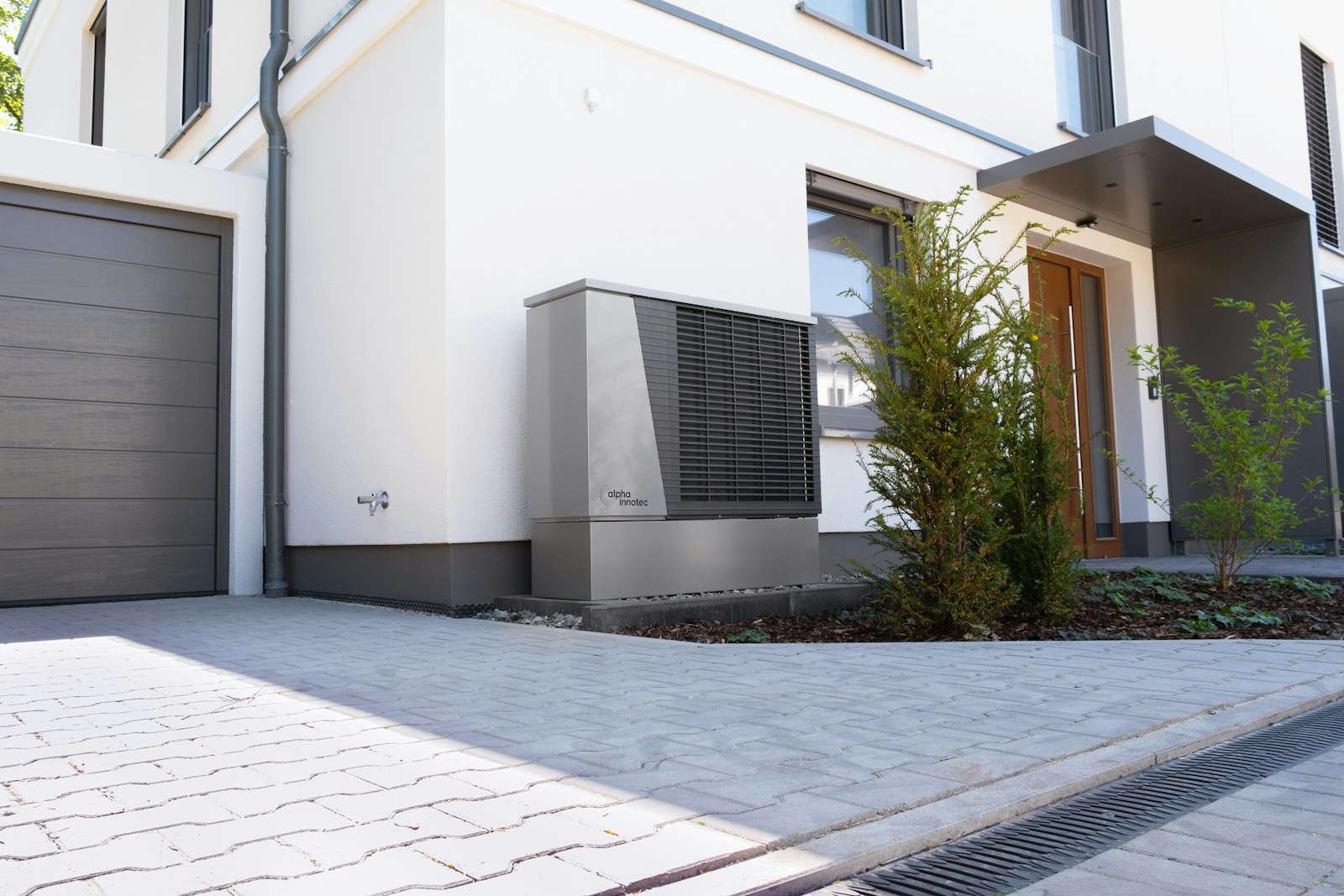 Modern residential heat pump installed beside a home